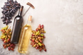 Two Wine bottles with grapes and wineglasses on old gray concrete table background with copy space. Two Wine bottles with grapes and wineglasses on old gray concrete table background with copy space. - PhotoDune Item for Sale