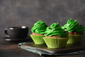 St. Patrick's Day coffee and chocolate cupcakes with green whipped cream. St. Patrick's Day coffee and chocolate cupcakes with green whipped cream. - PhotoDune Item for Sale
