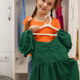 Happy child girl holding green dress in white wardrobe smiling Happy child girl holding green dress in white wardrobe smiling - PhotoDune Item for Sale