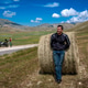 Motorcyclist relaxing on hay bale in Castelluccio, Italy Motorcyclist relaxing on hay bale in Castelluccio, Italy - PhotoDune Item for Sale