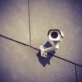 Security camera on gray office building wall Security camera on gray office building wall - PhotoDune Item for Sale