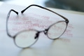 Reading glasses on top a paper with the red duplicate word Reading glasses on top a paper with the red duplicate word - PhotoDune Item for Sale