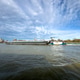 Inland cargo barge sailing the Nieuwe Maas river in Rotterdam under a dramatic, cloudy sky Inland cargo barge sailing the Nieuwe Maas river in Rotterdam under a dramatic, cloudy sky - PhotoDune Item for Sale