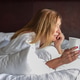 Woman laying on bed in morning with coffee Woman laying on bed in morning with coffee - PhotoDune Item for Sale