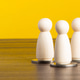 Wooden pawns standing on coins representing financial support Wooden pawns standing on coins representing financial support - PhotoDune Item for Sale