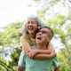 Glasses old man carrying a woman on his back and laughing together while standing or walking in park Glasses old man carrying a woman on his back and laughing together while standing or walking in park - PhotoDune Item for Sale