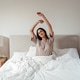 Happy woman stretching in bed after waking up, morning routine and healthy lifestyle Happy woman stretching in bed after waking up, morning routine and healthy lifestyle - PhotoDune Item for Sale