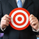 Businessman holding a target. Business marketing. Product target audience. Businessman holding a target. Business marketing. Product target audience. - PhotoDune Item for Sale