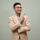 Smiling Asian businessman pointing finger up, standing against a green studio background Smiling Asian businessman pointing finger up, standing against a green studio background - PhotoDune Item for Sale