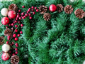 Flat lay of textured Christmas background of green garland artificial magenta berries and pinecones Flat lay of textured Christmas background of green garland artificial magenta berries and pinecones - PhotoDune Item for Sale