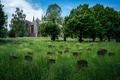 St Mary's Church and graveyard, tombstones surrounded by long green grass, parish church in England. St Mary's Church and graveyard, tombstones surrounded by long green grass, parish church in England. - PhotoDune Item for Sale