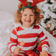 little curly cute girl in Christmas pajamas eats lollipop and tangerines sitting in bed. lifestyle little curly cute girl in Christmas pajamas eats lollipop and tangerines sitting in bed. lifestyle - PhotoDune Item for Sale