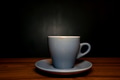 Coffee in blue cup on wooden table in cafe with dark background Coffee in blue cup on wooden table in cafe with dark background - PhotoDune Item for Sale