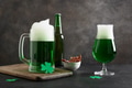Patrick's day green beer in pint on dark background. Shamrock symbol of luck. Patrick's day green beer in pint on dark background. Shamrock symbol of luck. - PhotoDune Item for Sale