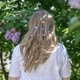 A blonde woman stands near blooming lilacs in a city park. Summer. A blonde woman stands near blooming lilacs in a city park. Summer. - PhotoDune Item for Sale