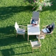 August 21, 2021: woman reads a book at the table in the garden, Italy August 21, 2021: woman reads a book at the table in the garden, Italy - PhotoDune Item for Sale