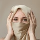 Portrait of a beautiful oriental woman covered with a headscarf Portrait of a beautiful oriental woman covered with a headscarf - PhotoDune Item for Sale