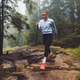 A person running through a misty forest, navigating over tree roots and muddy ground. The scene capt A person running through a misty forest, navigating over tree roots and muddy ground. The scene capt - PhotoDune Item for Sale
