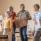 A mother and her kids are unpacking boxes and moving into their new home. A mother and her kids are unpacking boxes and moving into their new home. - PhotoDune Item for Sale