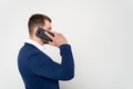 Close up of young business man in suit speaks on cell phone on white background Close up of young business man in suit speaks on cell phone on white background - PhotoDune Item for Sale
