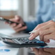 Businessman hands using a calculator to check company finances and earnings and budget. Businessman hands using a calculator to check company finances and earnings and budget. - PhotoDune Item for Sale