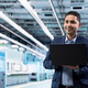Smiling man in microchip factory assessing hardware performance using laptop Smiling man in microchip factory assessing hardware performance using laptop - PhotoDune Item for Sale