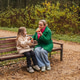 Sitting mother with daughter on park bench. Family talk, smile supports love, care, trust. Outdoor Sitting mother with daughter on park bench. Family talk, smile supports love, care, trust. Outdoor - PhotoDune Item for Sale
