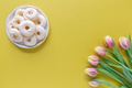Easter greeting card template on yellow background with sweet meringues on a plate and tulips Easter greeting card template on yellow background with sweet meringues on a plate and tulips - PhotoDune Item for Sale