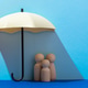 A set of wooden peg dolls representing a small family huddling together under an umbrella. A set of wooden peg dolls representing a small family huddling together under an umbrella. - PhotoDune Item for Sale