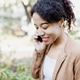 Young Multiracial Woman Talking on Smartphone Outdoors, smiling Young Multiracial Woman Talking on Smartphone Outdoors, smiling - PhotoDune Item for Sale