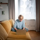 Focused relaxed middle aged businesswoman sitting comfortably on cozy couch working on laptop. Focused relaxed middle aged businesswoman sitting comfortably on cozy couch working on laptop. - PhotoDune Item for Sale