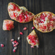 Pomegranate sections on wood table Pomegranate sections on wood table - PhotoDune Item for Sale