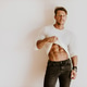 Brutal muscular man showing six pack abs muscles indoors Brutal muscular man showing six pack abs muscles indoors - PhotoDune Item for Sale