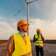 Engineers standing in field with wind turbines Engineers standing in field with wind turbines - PhotoDune Item for Sale