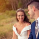 Portrait of a bride smiling at the groom at sunset near the forest Portrait of a bride smiling at the groom at sunset near the forest - PhotoDune Item for Sale