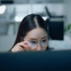 Serious Asian female software developer thinking while working at computer in modern office. Serious Asian female software developer thinking while working at computer in modern office. - PhotoDune Item for Sale