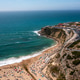 Drone view of scenic Magoito Beach with town on cliffs during daytime Drone view of scenic Magoito Beach with town on cliffs during daytime - PhotoDune Item for Sale
