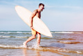 Mature man carrying a surfboard Mature man carrying a surfboard - PhotoDune Item for Sale