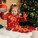 Little girl opens a Christmas present near the Christmas tree Little girl opens a Christmas present near the Christmas tree - PhotoDune Item for Sale