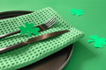 St Patrick's Day table setting with shamrock, clover leaves on green background. St Patrick's Day table setting with shamrock, clover leaves on green background. - PhotoDune Item for Sale