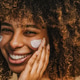 Beautiful black woman applying face luxury sunscreen or moisturizer cream Beautiful black woman applying face luxury sunscreen or moisturizer cream - PhotoDune Item for Sale