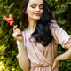 A young beautiful girl in a pale pink dress on the background of a green park A young beautiful girl in a pale pink dress on the background of a green park - PhotoDune Item for Sale