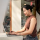 A beautiful Asian woman focuses on working on her laptop, working remotely from a cafe. A beautiful Asian woman focuses on working on her laptop, working remotely from a cafe. - PhotoDune Item for Sale