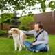 Young man owner walking with his large dog in public park on spring day. Pet care Young man owner walking with his large dog in public park on spring day. Pet care - PhotoDune Item for Sale