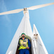 Engineer inspecting wind turbine, using wrench Engineer inspecting wind turbine, using wrench - PhotoDune Item for Sale