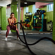 Young athletic woman working out with battle ropes in a gym Young athletic woman working out with battle ropes in a gym - PhotoDune Item for Sale