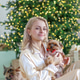 A woman in pajamas at home with a Yorkshire terrier against the background of a Christmas tree A woman in pajamas at home with a Yorkshire terrier against the background of a Christmas tree - PhotoDune Item for Sale