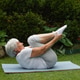 an age-old gray-haired woman does therapeutic exercises to stretch the muscles of the back, spine. an age-old gray-haired woman does therapeutic exercises to stretch the muscles of the back, spine. - PhotoDune Item for Sale