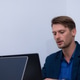 Professional man working on laptop in modern office environment, wearing blue blazer and blue shirt Professional man working on laptop in modern office environment, wearing blue blazer and blue shirt - PhotoDune Item for Sale