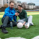 Friends enjoying time on a sports field while looking at a mobile phone together Friends enjoying time on a sports field while looking at a mobile phone together - PhotoDune Item for Sale